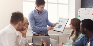 Man giving presentation to colleagues in office
